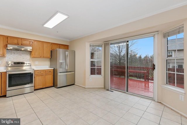 kitchen featuring backsplash, light tile patterned floors, ornamental molding, and appliances with stainless steel finishes