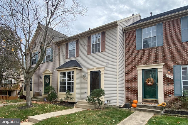 view of property featuring a front lawn