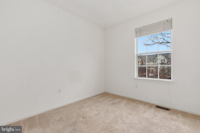 unfurnished room with light colored carpet