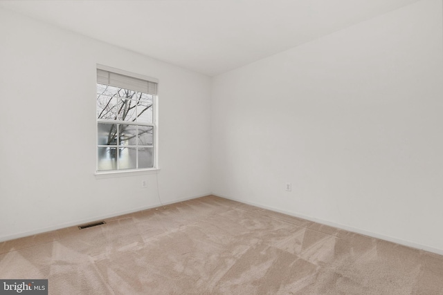 unfurnished room featuring light colored carpet