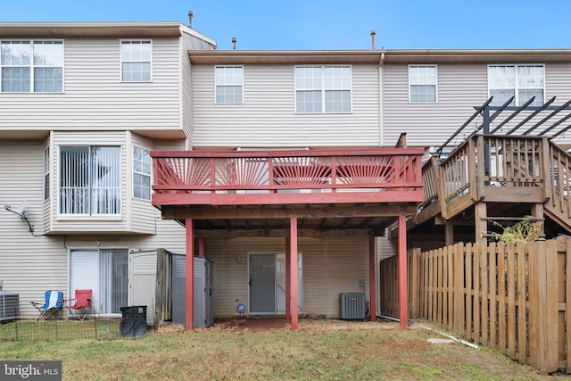 rear view of house with a pergola, central AC unit, and a deck