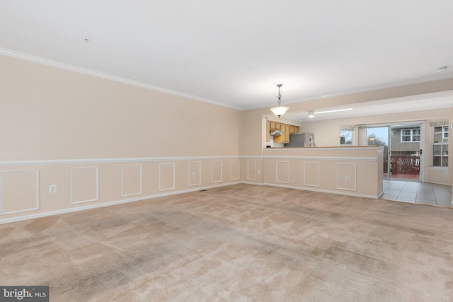 empty room with light colored carpet and crown molding