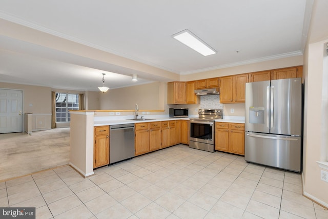 kitchen with kitchen peninsula, appliances with stainless steel finishes, light colored carpet, sink, and pendant lighting