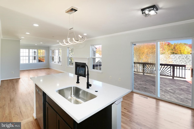 kitchen featuring dishwasher, sink, light hardwood / wood-style floors, and ornamental molding