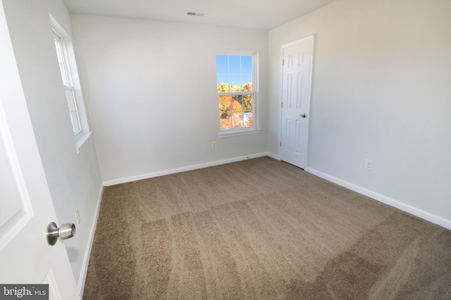 unfurnished room featuring carpet