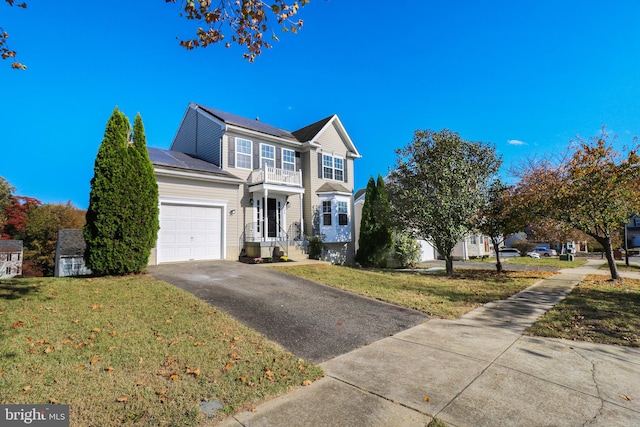 view of front of property with a front yard and a garage