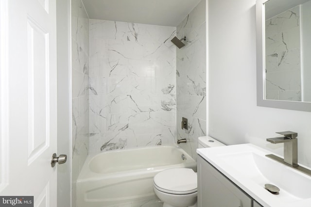 full bathroom with toilet, vanity, and tiled shower / bath