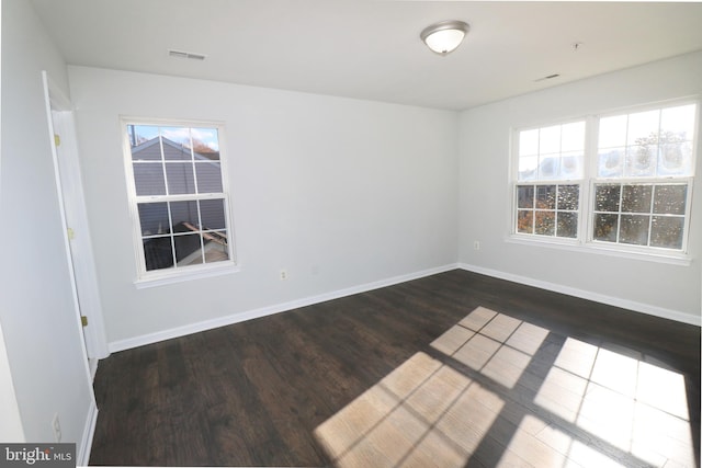 empty room featuring dark wood-type flooring