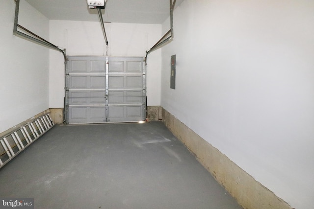 garage featuring electric panel and a garage door opener