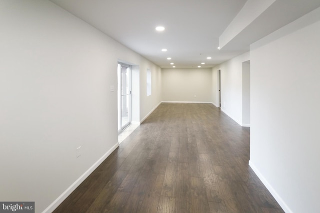 empty room with dark hardwood / wood-style flooring