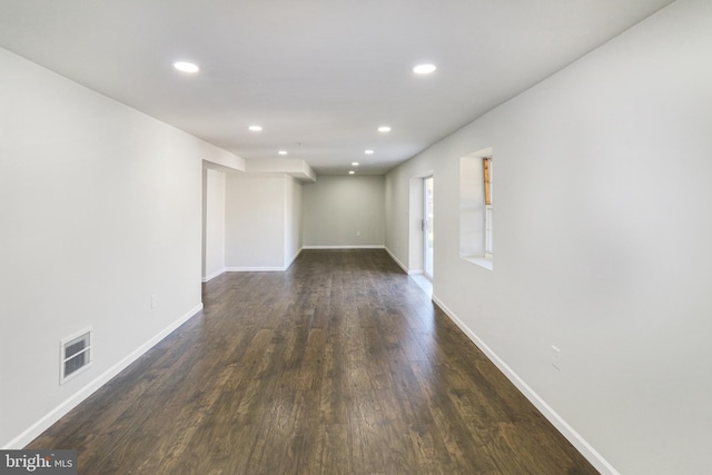 unfurnished room with dark hardwood / wood-style flooring