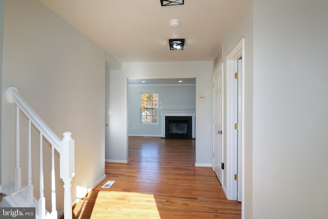 hallway with hardwood / wood-style floors