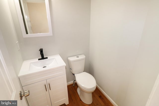 bathroom featuring vanity, toilet, and wood-type flooring