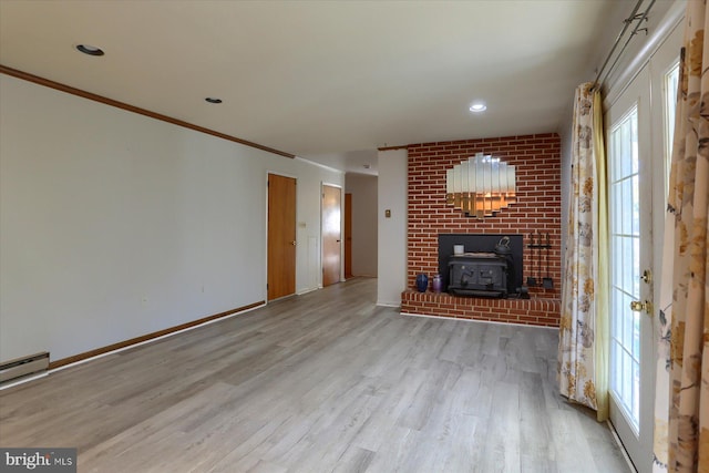 unfurnished living room featuring crown molding, a baseboard heating unit, light wood-type flooring, and a wood stove