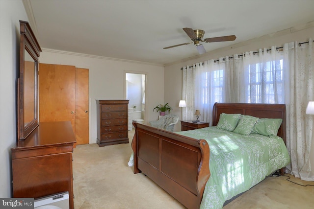 bedroom with crown molding, ensuite bath, ceiling fan, and light carpet