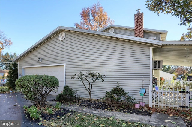 view of side of home with a garage