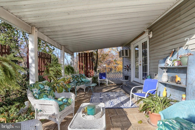 view of patio featuring french doors and a wall mounted AC