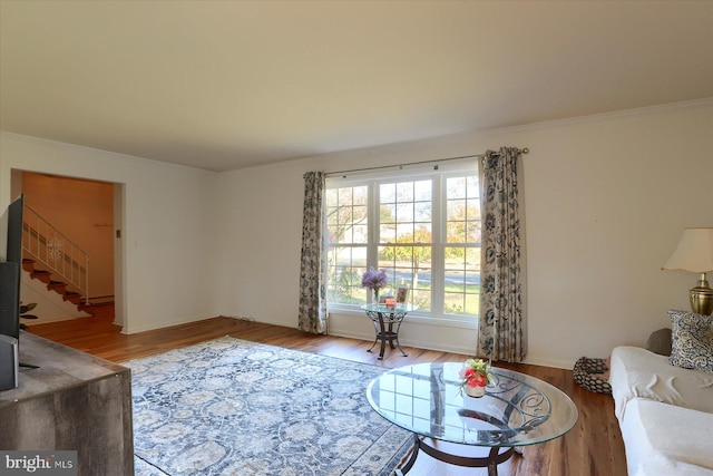 living room with crown molding and hardwood / wood-style floors