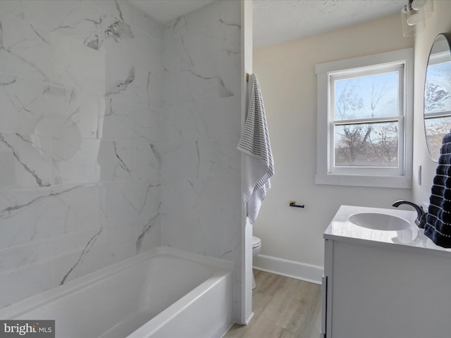 bathroom with toilet, hardwood / wood-style flooring, and vanity