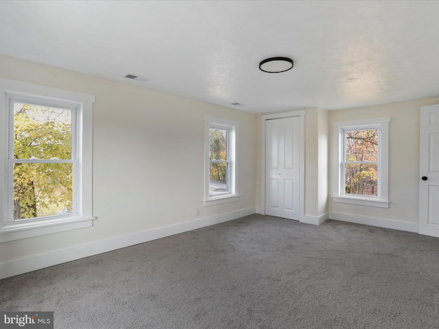 unfurnished bedroom featuring a closet and carpet