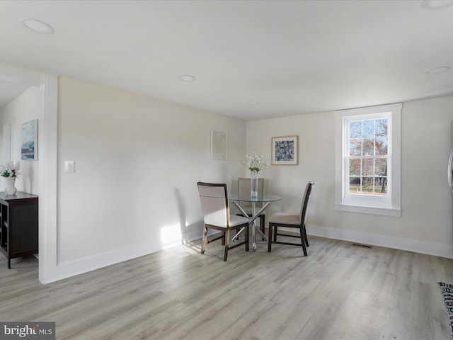 dining space with light hardwood / wood-style flooring