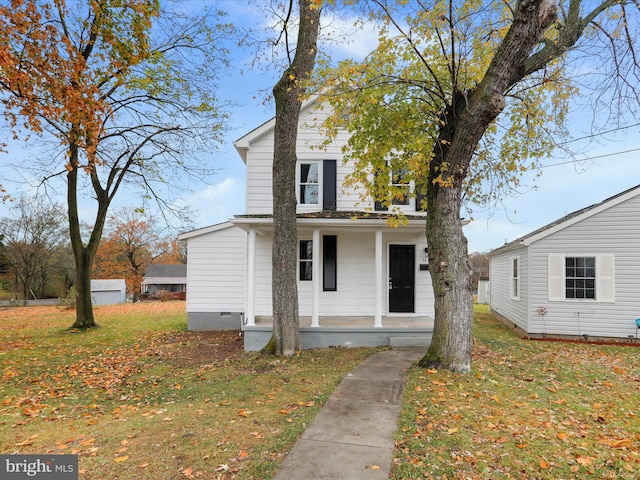 view of front of house with a front yard and covered porch