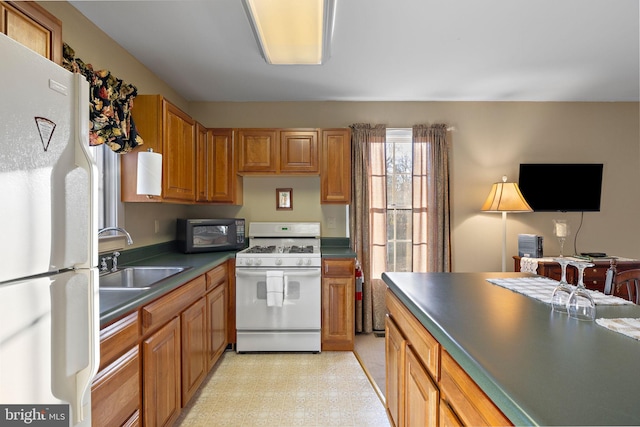 kitchen with sink and white appliances