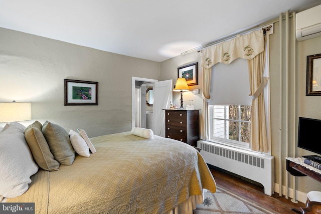 bedroom featuring radiator heating unit, dark wood-type flooring, and a wall mounted AC