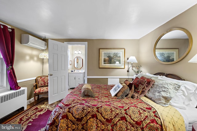 bedroom featuring radiator heating unit, connected bathroom, and an AC wall unit