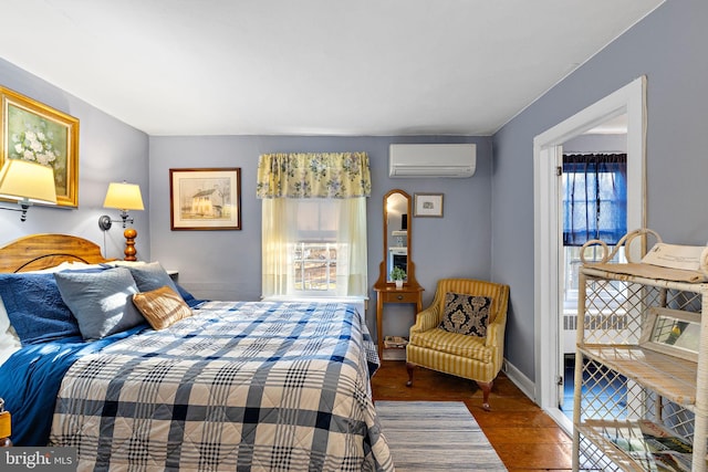 bedroom with wood-type flooring and an AC wall unit