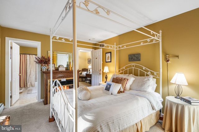 carpeted bedroom with ensuite bath