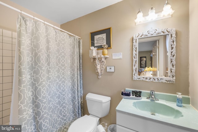 bathroom featuring vanity, a shower with shower curtain, and toilet