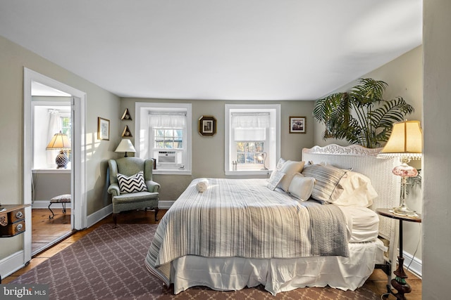 bedroom with dark hardwood / wood-style floors and cooling unit