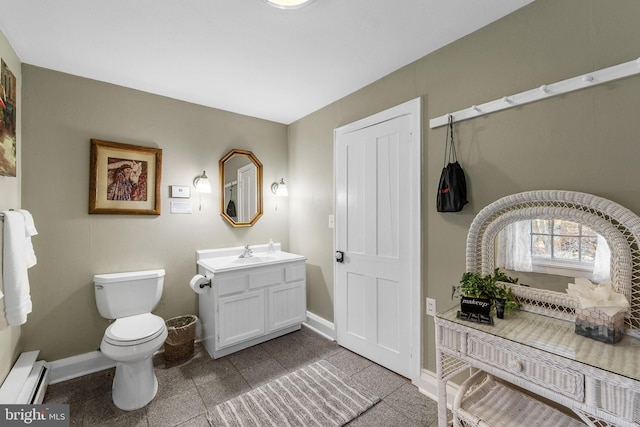 bathroom featuring tile patterned flooring, vanity, a baseboard radiator, and toilet