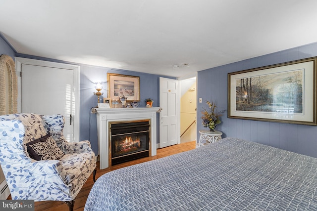 1324 River Rd, New Hope, PA 18938 - bedroom featuring wood finished floors and a glass covered fireplace