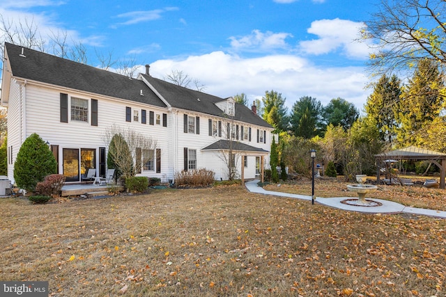 view of front of house with a patio area and a front yard