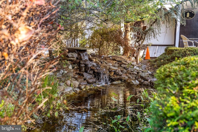 exterior space with a garden pond