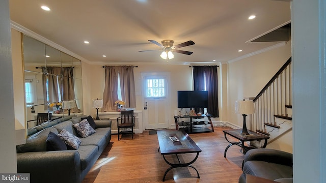 living room with ceiling fan, light hardwood / wood-style floors, and ornamental molding