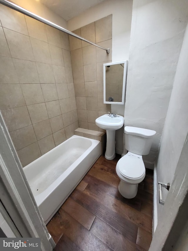 bathroom featuring hardwood / wood-style floors and toilet