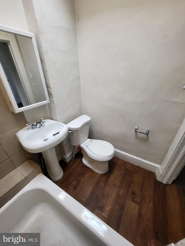 bathroom featuring wood-type flooring, sink, and toilet