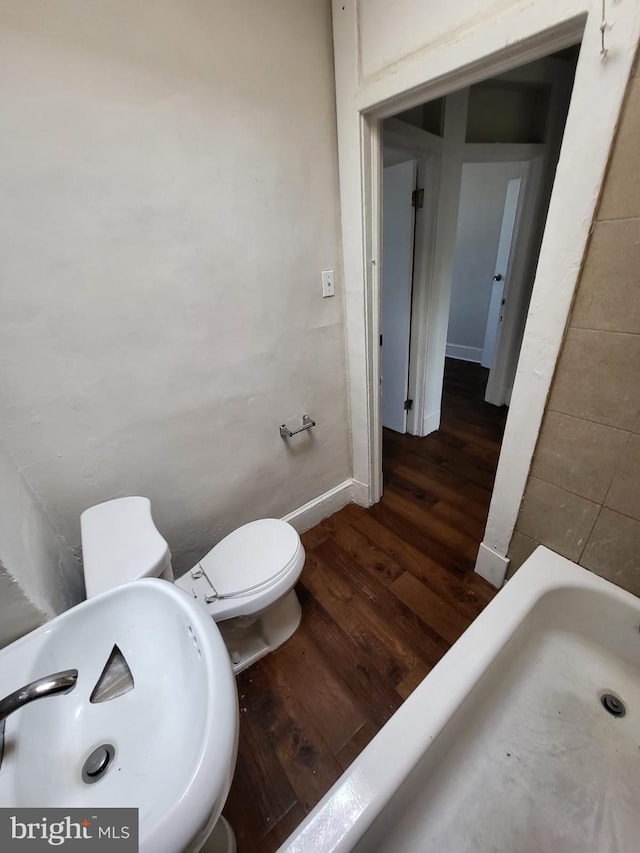 bathroom featuring hardwood / wood-style floors, sink, and toilet