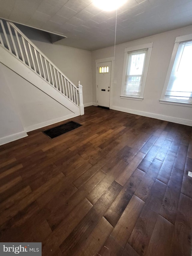 entrance foyer with plenty of natural light and dark wood-type flooring