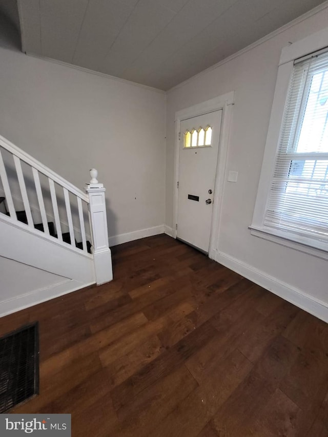 foyer featuring dark hardwood / wood-style flooring and ornamental molding