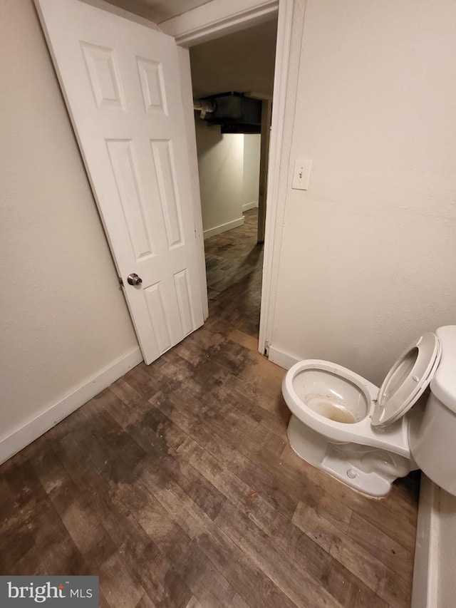 bathroom with toilet and hardwood / wood-style flooring