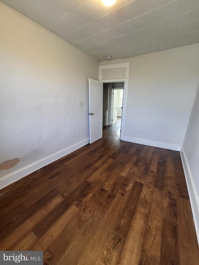 spare room with dark hardwood / wood-style flooring