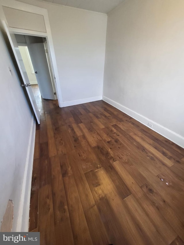 spare room featuring dark wood-type flooring