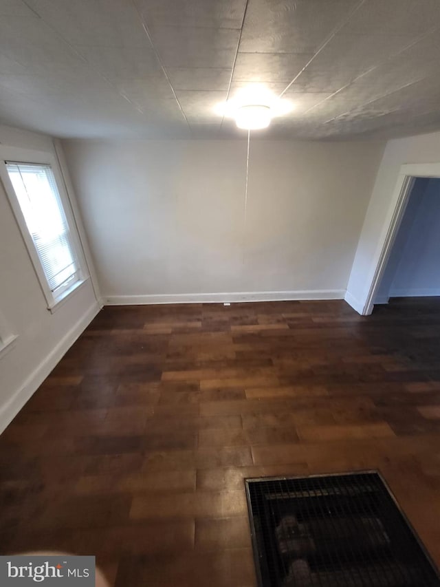 unfurnished room with a fireplace and dark hardwood / wood-style floors