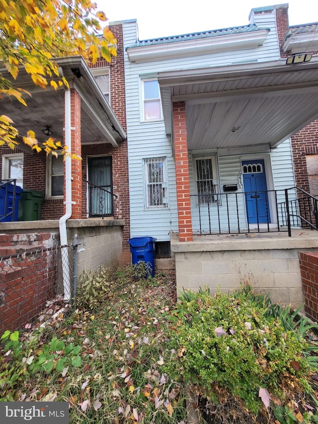 back of property with covered porch