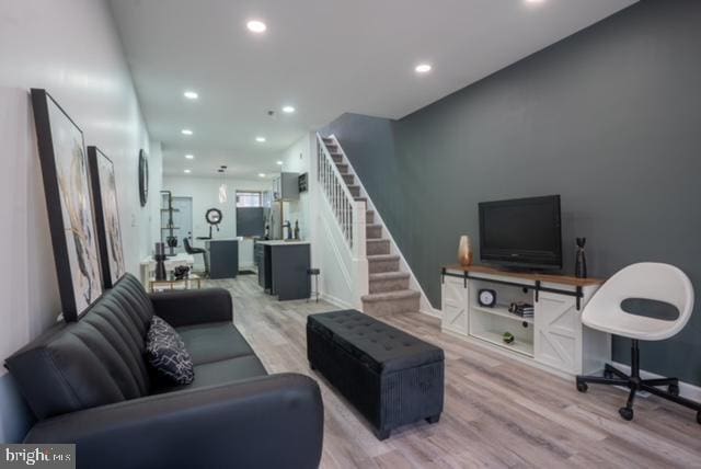 2614 Grogan Ave, Baltimore, MD 21213 - living room with light wood-type flooring, recessed lighting, stairway, and baseboards