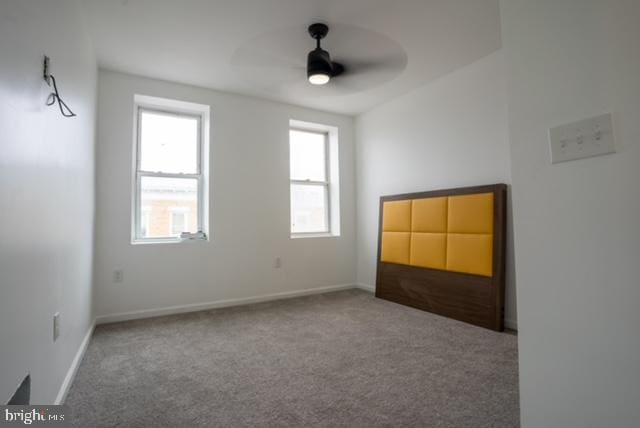 carpeted empty room with ceiling fan